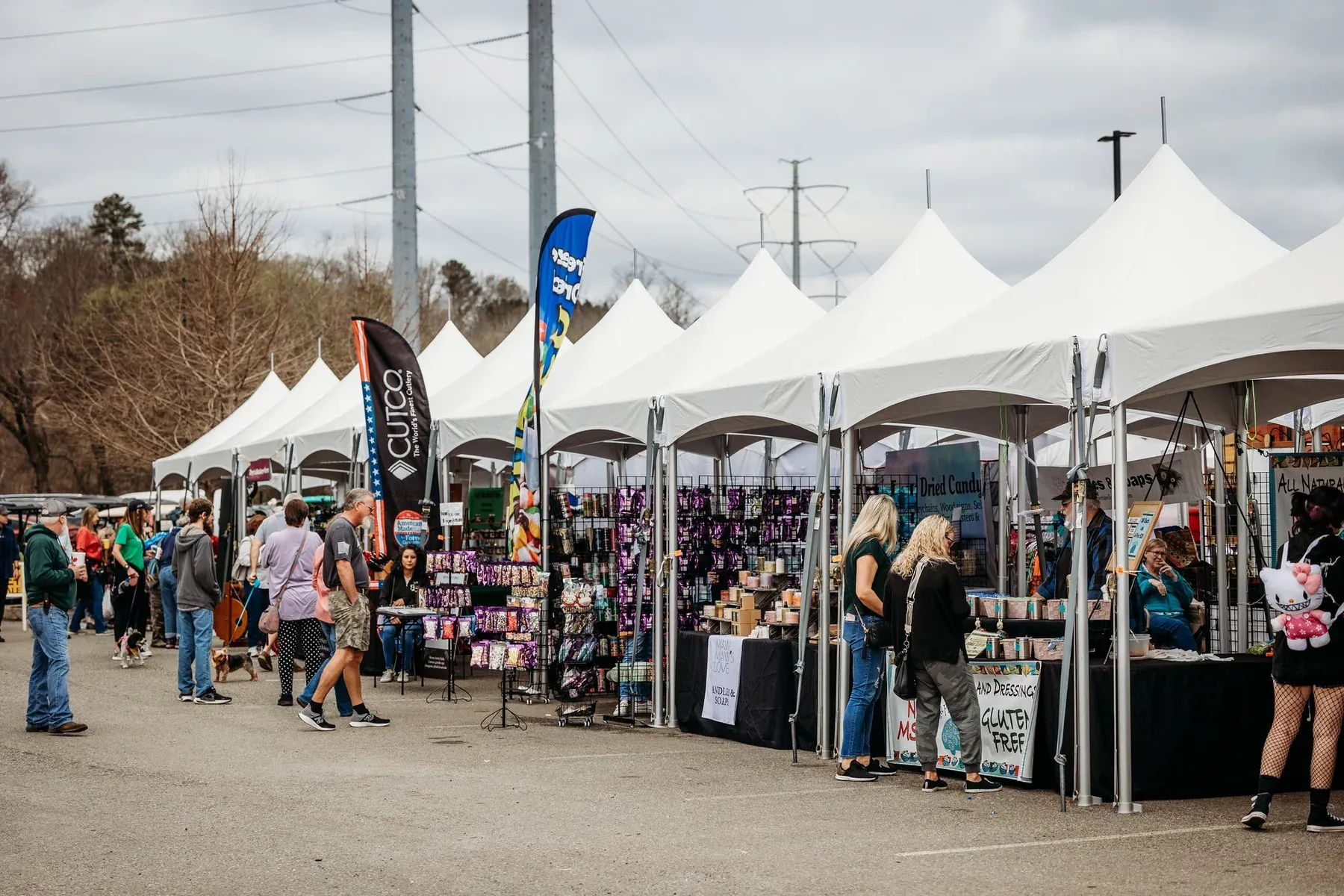 White event tents along an outdoor festival walkway
