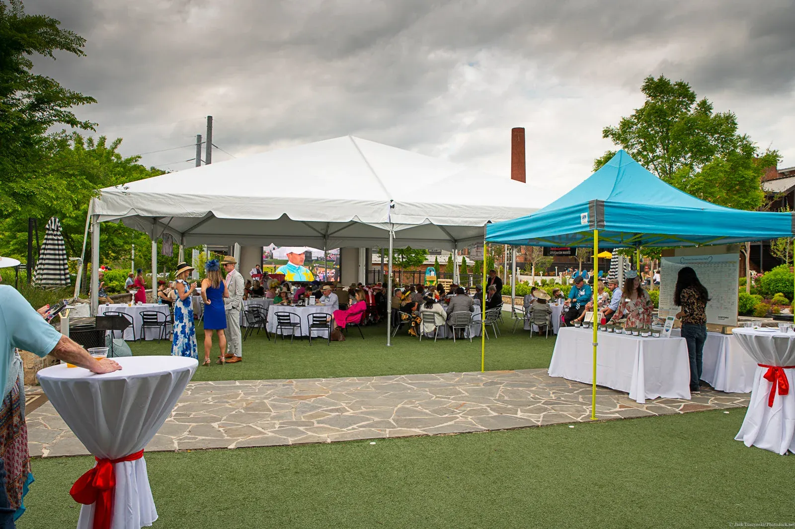 Outdoor event tents set beside a garden walkway