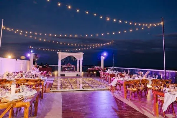 Evening reception with string lights and gold chairs
