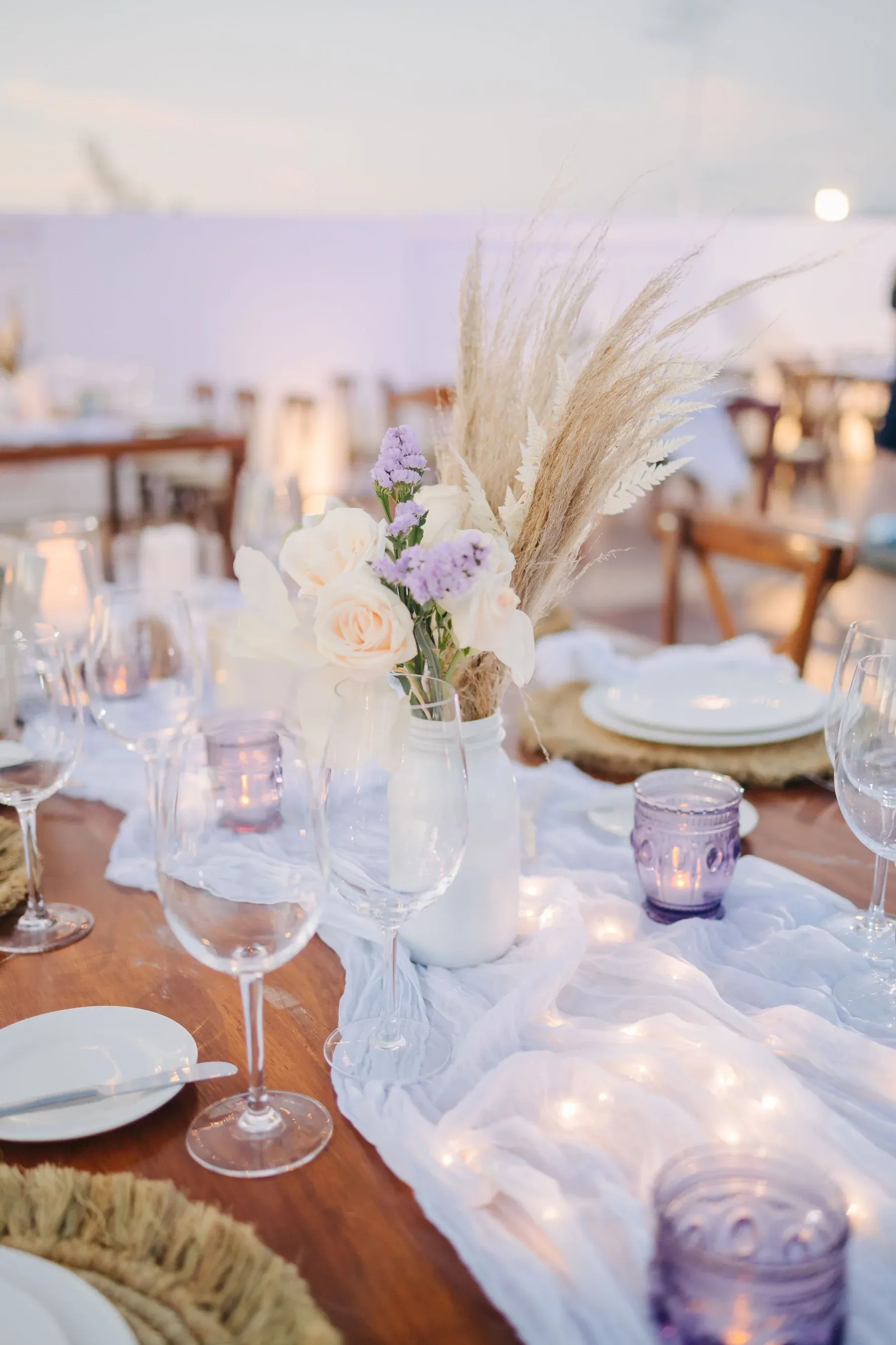Floral table setting with glasses and layered dinnerware