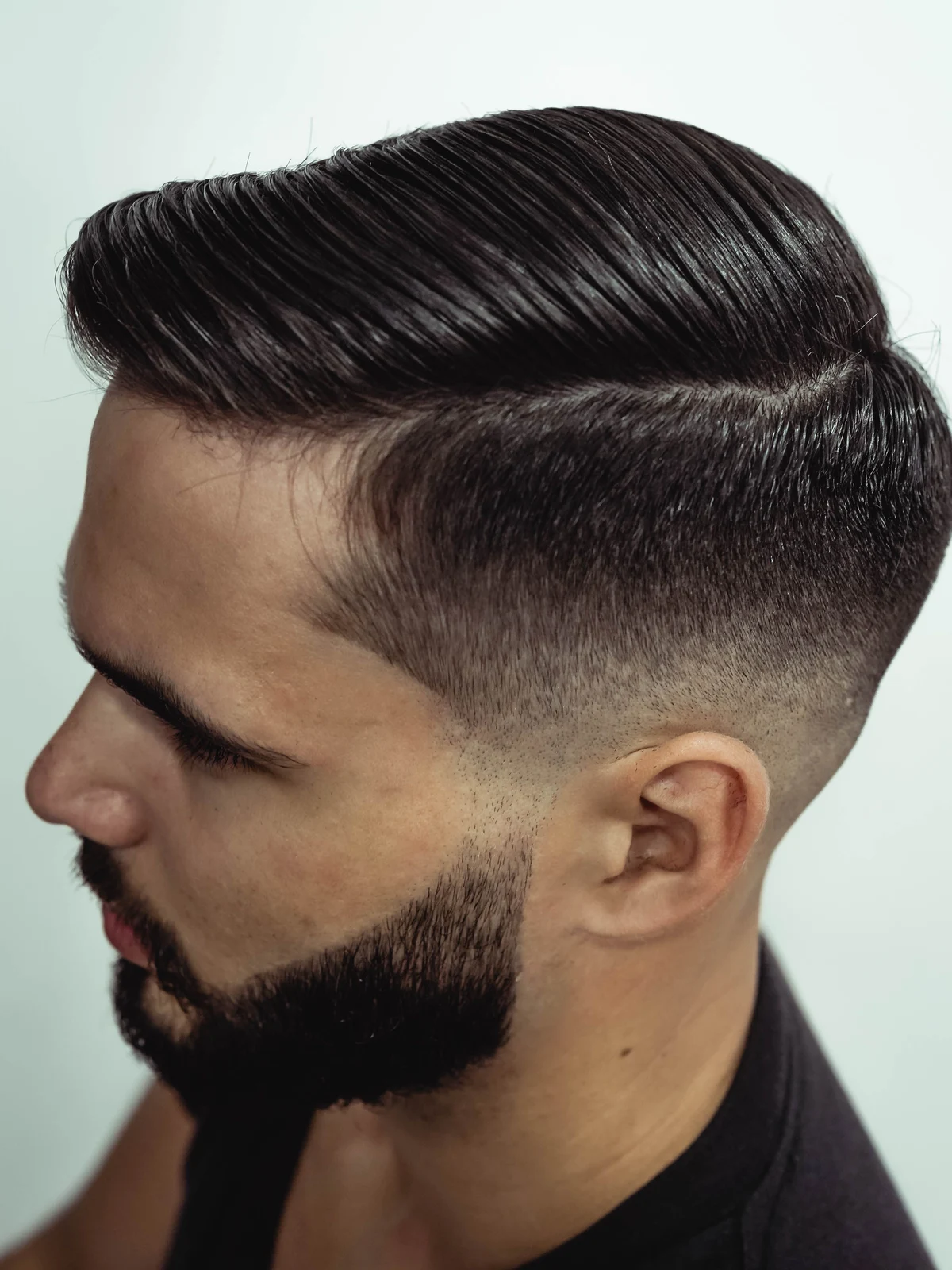 Stock photograph of a tapered haircut and shaped beard in profile