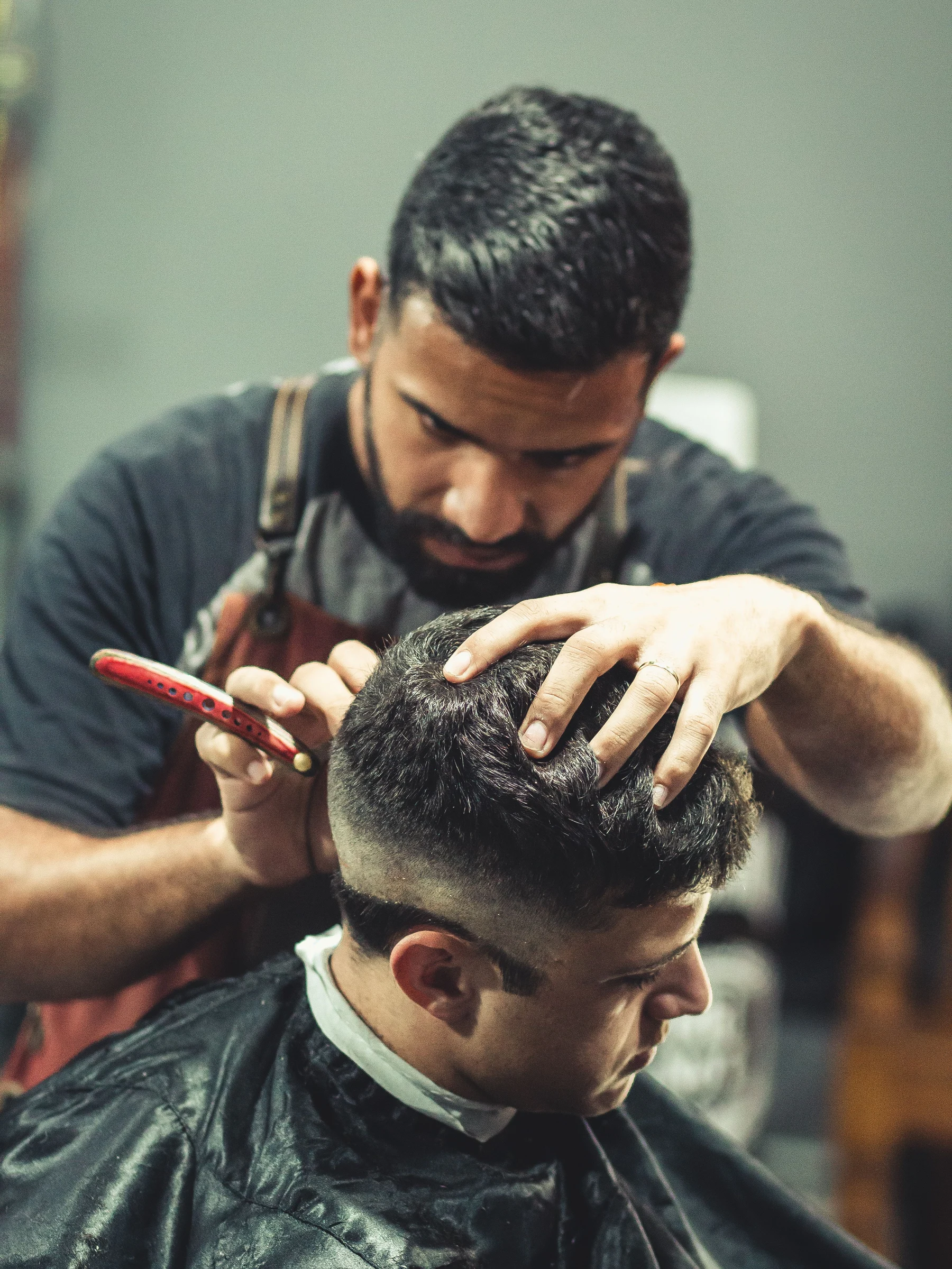 Stock photograph of a barber at work in a traditional shop