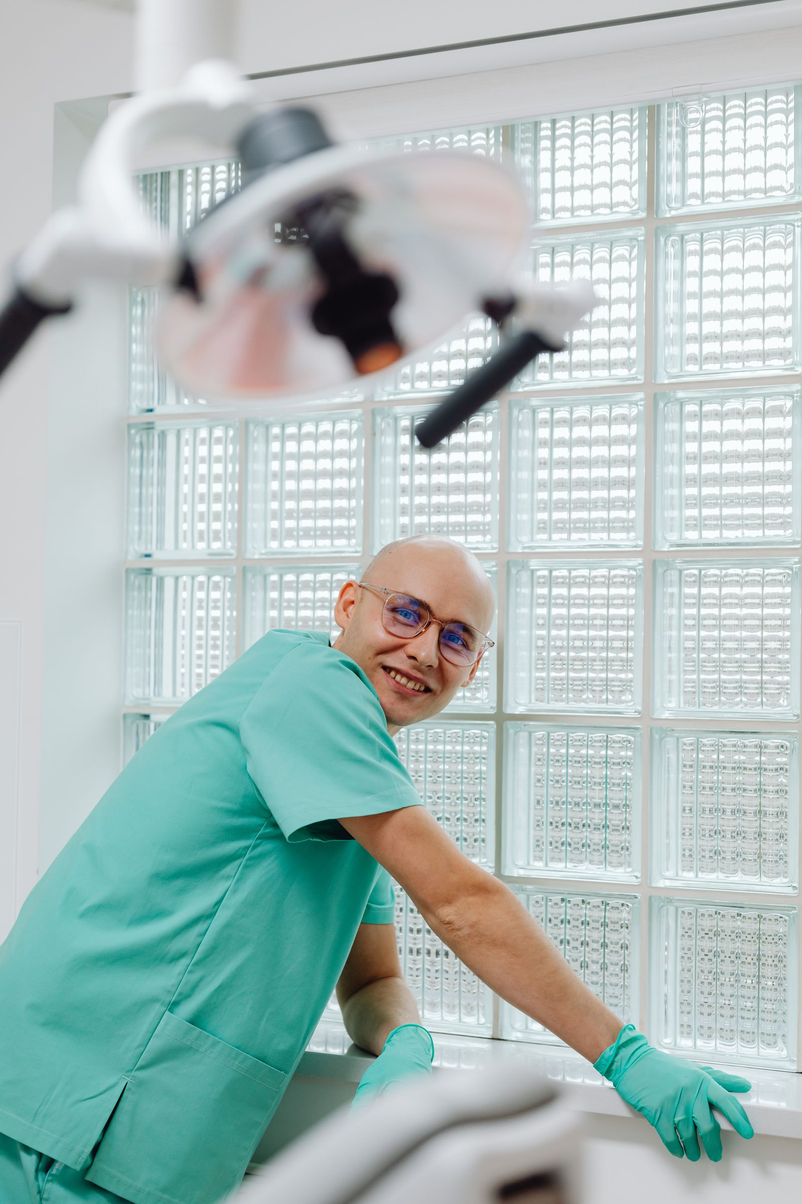 A smiling dentist in a naturally lit office